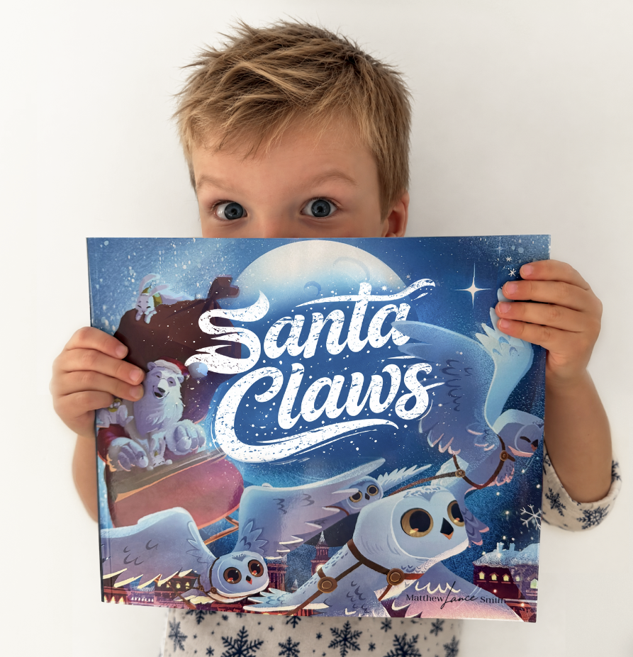 Child holding Santa Claws with the illustrated front cover facing the camera